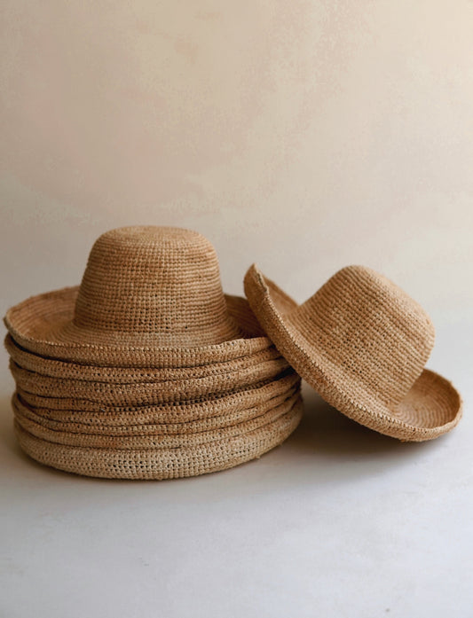 Reshaping a raffia straw hat by hand